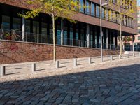 the large building is made of concrete and has metal railings around it, which are made of brick