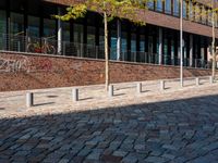 the large building is made of concrete and has metal railings around it, which are made of brick