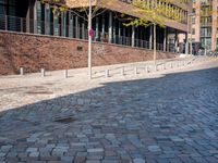 the large building is made of concrete and has metal railings around it, which are made of brick