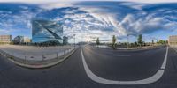 a view of a road in a big city at the day time, from a fisheye lens