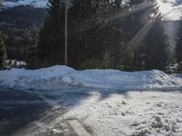 a pile of snow in the middle of the road with a street light in the distance