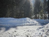 a pile of snow in the middle of the road with a street light in the distance