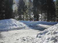 a pile of snow in the middle of the road with a street light in the distance