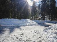 a pile of snow in the middle of the road with a street light in the distance