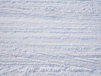 a person is skiing down the ski slope on a snowy day wearing red pants and white socks