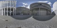 this photo shows the front view of buildings in a different way, both as a sphere with a reflection and the front