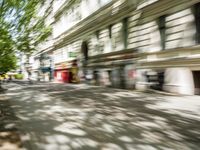 a restaurant in the middle of a narrow city street with graffiti on the wall and the sidewalk outside the building