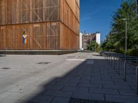 a group of people riding skateboards near wooden panels and stairss with artwork on them