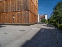 a group of people riding skateboards near wooden panels and stairss with artwork on them