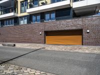 the exterior of a modern residential apartment building with a yellow garage door on the front