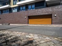 the exterior of a modern residential apartment building with a yellow garage door on the front