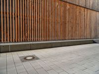 a group of people riding skateboards near wooden panels and stairss with artwork on them