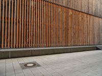 a group of people riding skateboards near wooden panels and stairss with artwork on them