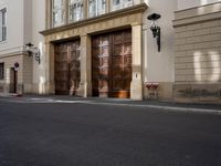a parking meter on a street in front of doors and a building in the background