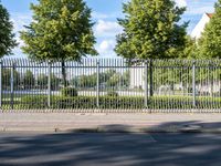 an empty road next to the side of a road with several trees lining both sides