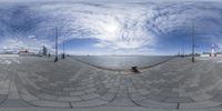 the skateboarder is practicing his tricks on the rail outdoors by the water's edge