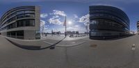 a fish eye view looking down at a building with a clock in it and a sky background