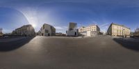 a round panorama of various buildings on a sunny day with some blue sky in the background