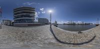 this is an image of a circular shot of some buildings near a river thames by itself