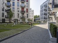 an outside area with a lawn and several balconies in the area and two birds in the area