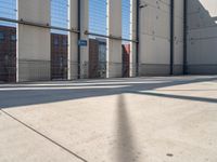 a parking garage with several small sections of concrete in front of a fenced off area