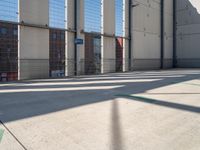 a parking garage with several small sections of concrete in front of a fenced off area