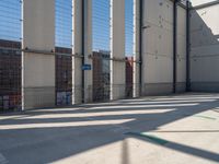 a parking garage with several small sections of concrete in front of a fenced off area