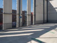 a parking garage with several small sections of concrete in front of a fenced off area