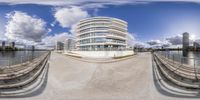 a wide angle lens photo of a modern city, taken from a small balcony, on a sunny day