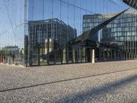 modern glass buildings reflecting in an open courtyard of an office complex of an architectural city