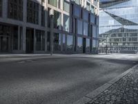 a empty city street is pictured in this image of a few buildings with windows on each side of it