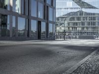 a empty city street is pictured in this image of a few buildings with windows on each side of it