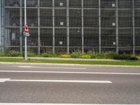 an empty street with many traffic signs in front of it and many building behind it