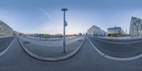 a view of a street corner taken through a fisheye lens as the sun is setting