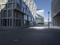 a city street with two tall buildings on either side of it, one is empty