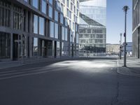 a city street with two tall buildings on either side of it, one is empty