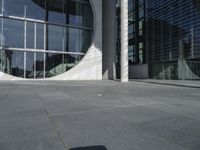 an image of a person on a skateboard in the street of a modern building