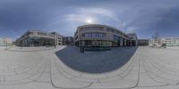 the exterior of a modern office building is being reflected by a 3d sphere mirror image