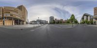 a view from a 360 - lens of a street in a city center with buildings and street signs