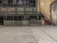 a small kid is playing baseball outside the building on his skateboard's pavement