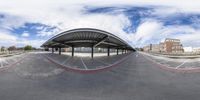 a fish - eye view of a train station that sits on the tracks near a park