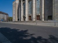 an entrance of a building with large columns and doors that spell out the word voltege