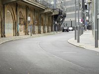 a man on a skateboard is riding on a street corner next to tall buildings