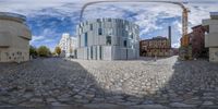 a photo taken through the lens of an eye view of buildings and street in a city