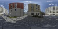 360 view of a street with several buildings in the background from a fish eye lens