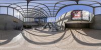 a spherical view of a person skating on some stairs outside a building with large circular mirrors