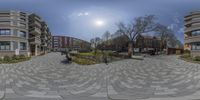 a building and park are viewed from a 360 - view camera view in this circular photo