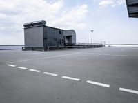 a boat is parked in an empty parking lot near an air port on the water