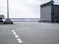 a boat is parked in an empty parking lot near an air port on the water