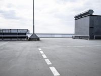 a boat is parked in an empty parking lot near an air port on the water
